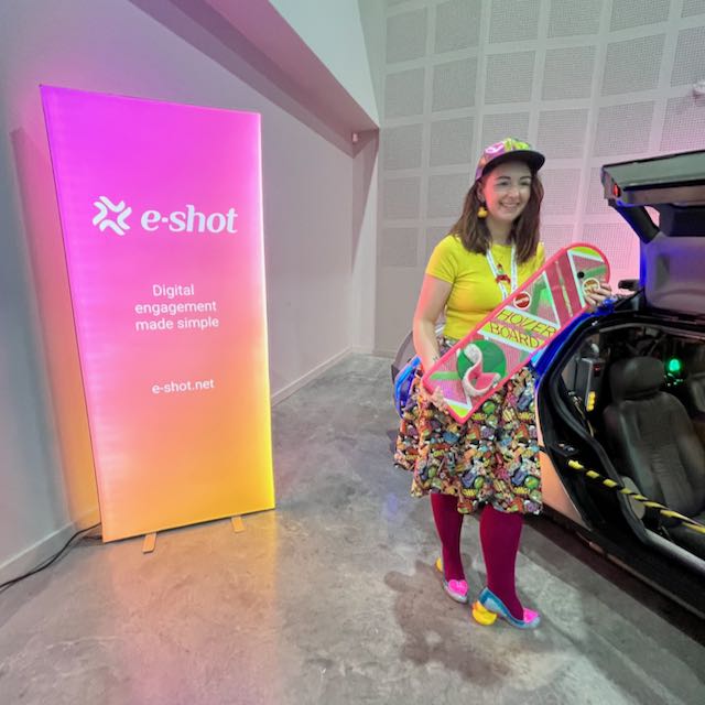 Attendee with the hoverboard in a well matched outfit and an e-shot banner